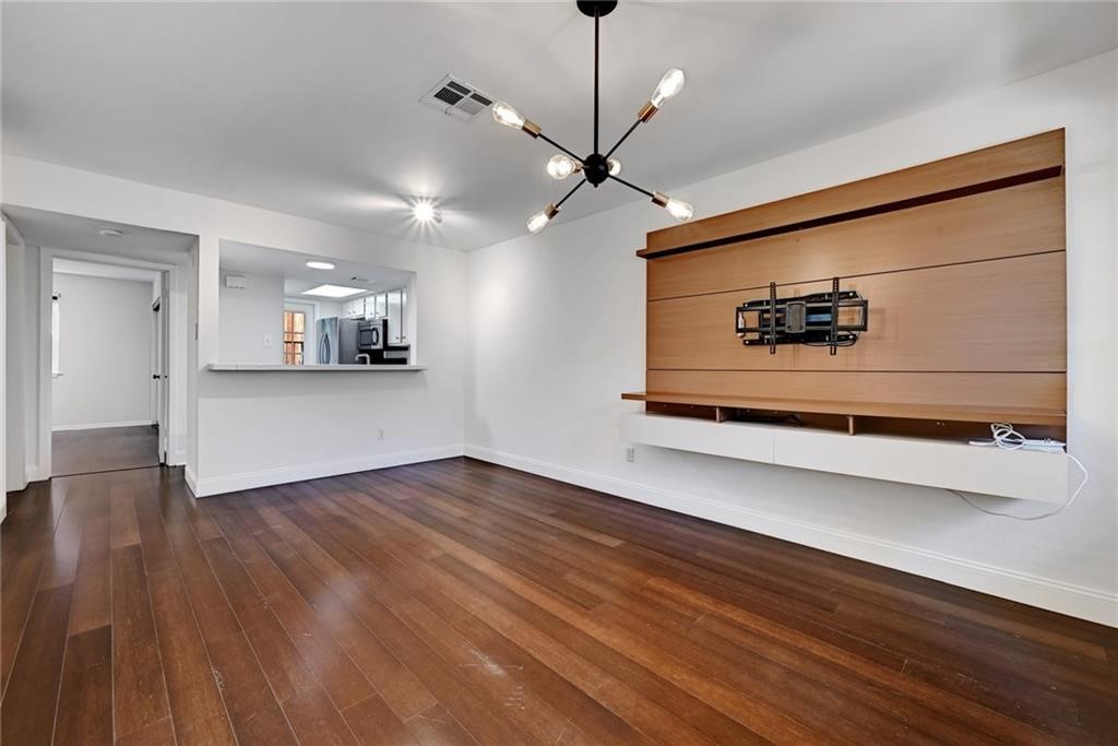 2104 Cullen Avenue, Unit 4117 Austin, TX 78757 - Photo 19 of 36 a view of a room with wooden floor and a ceiling fan