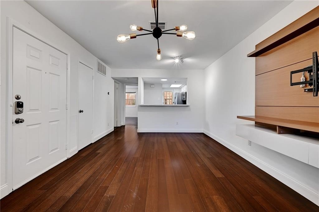 2104 Cullen Avenue, Unit 4117 Austin, TX 78757 - Photo 20 of 36 a view of a room with wooden floor and a ceiling fan