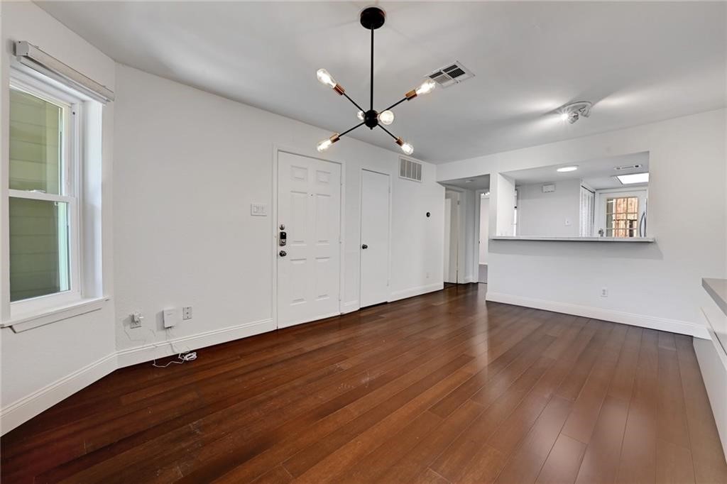 2104 Cullen Avenue, Unit 4117 Austin, TX 78757 - Photo 21 of 36 a view of a room with wooden floor and a ceiling fan