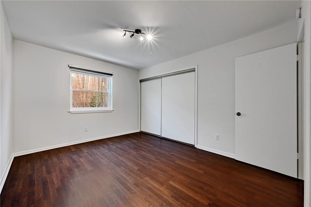 2104 Cullen Avenue, Unit 4117 Austin, TX 78757 - Photo 29 of 36 a view of an empty room with wooden floor and a window