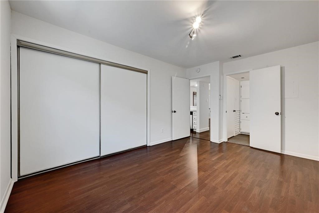 2104 Cullen Avenue, Unit 4117 Austin, TX 78757 - Photo 30 of 36 a view of an empty room with wooden floor