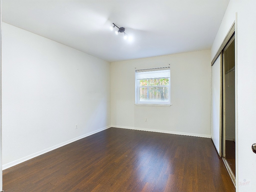 2104 Cullen Avenue, Unit 4117 Austin, TX 78757 - Photo 4 of 36 an empty room with wooden floor and windows