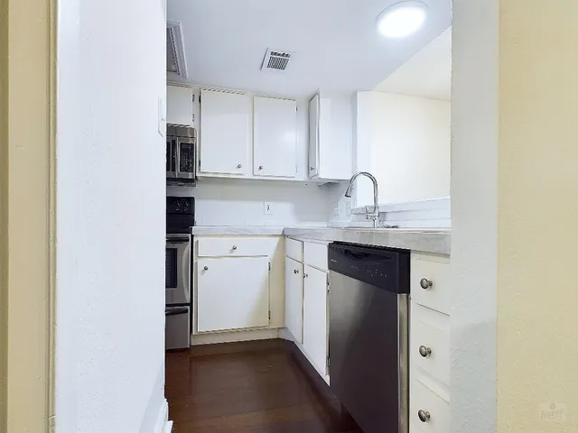 a kitchen with a sink and cabinets