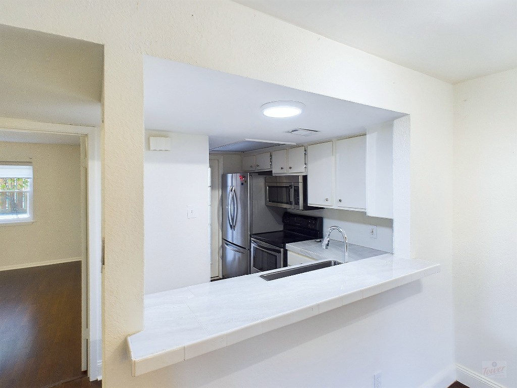 2104 Cullen Avenue, Unit 4117 Austin, TX 78757 - Photo 7 of 36 a kitchen with stainless steel appliances a refrigerator and a counter top space