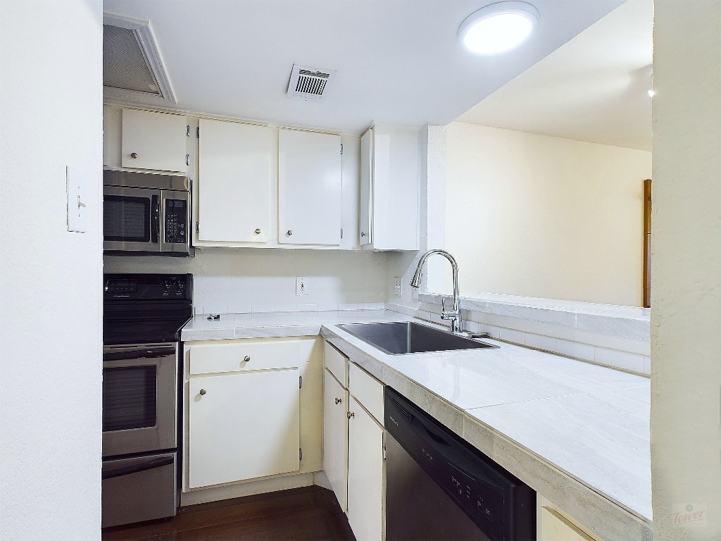 2104 Cullen Avenue, Unit 4117 Austin, TX 78757 - Photo 9 of 36 a view of a sink and dishwasher in a kitchen