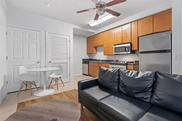 a living room with furniture and a wooden floor
