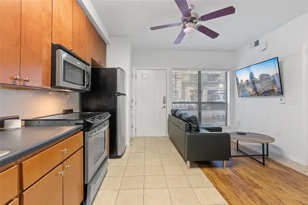 a kitchen with stainless steel appliances granite countertop a stove a sink and a microwave