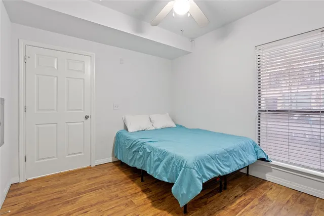 a bedroom with a bed and painting on the wall