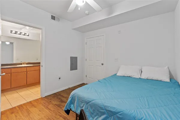 a bedroom with a bed and cabinets