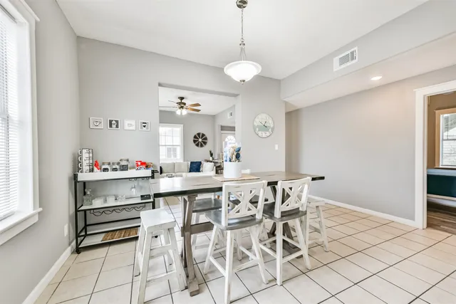 a view of a dining room with furniture and chandelier
