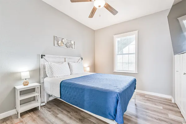 a bedroom with a large bed and a flat screen tv