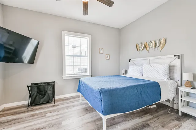 a bedroom with a large bed and a window