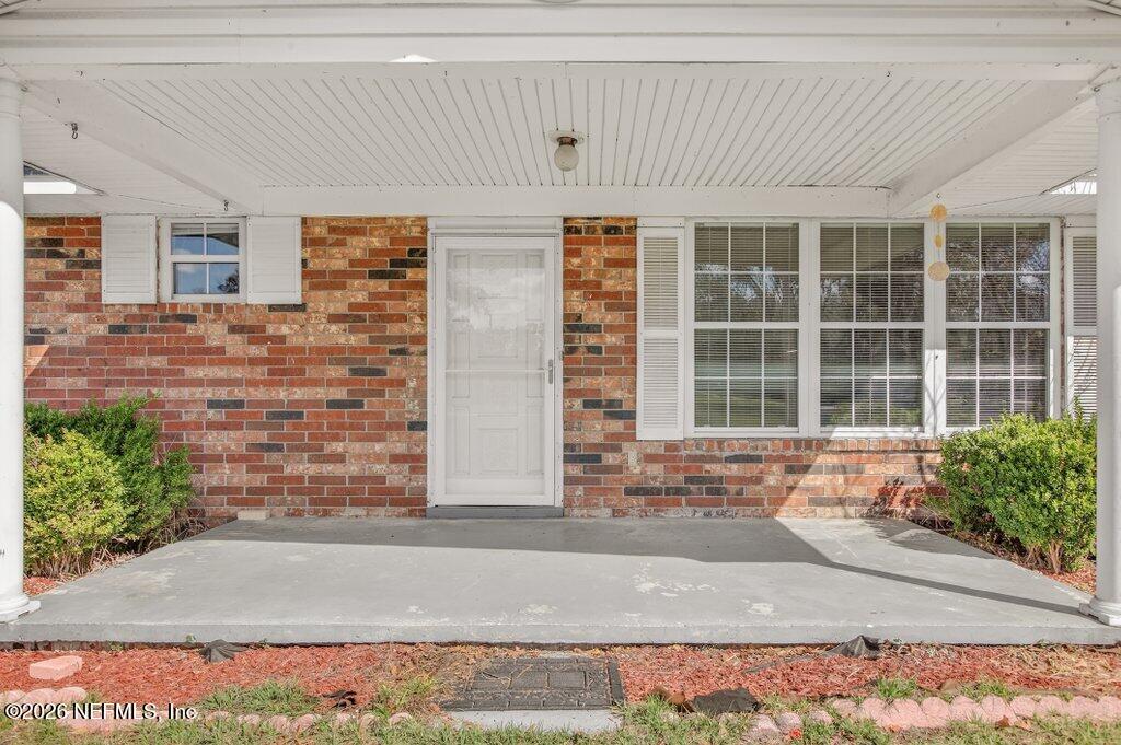 5785 George Hodges Road Macclenny, FL 32063 - Photo 11 of 55 a front view of a house with a yard and garage