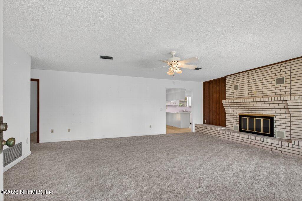 5785 George Hodges Road Macclenny, FL 32063 - Photo 12 of 55 a view of empty room with a fireplace