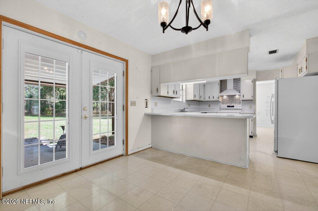 5785 George Hodges Road Macclenny, FL 32063 - Photo 19 of 55 a view of kitchen with stainless steel appliances granite countertop a refrigerator a sink a stove and white cabinets