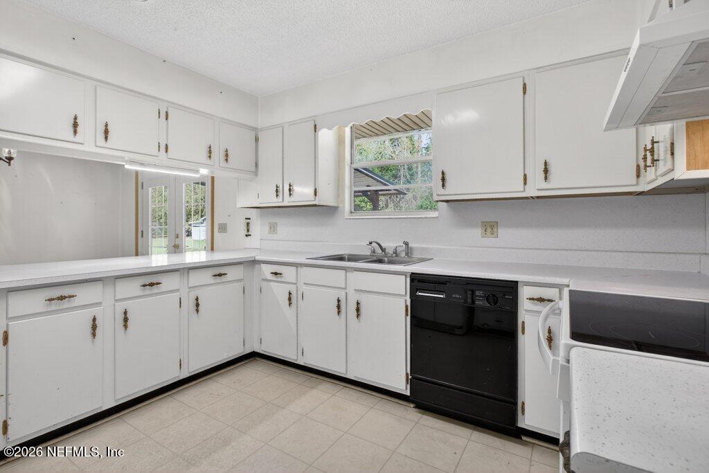 5785 George Hodges Road Macclenny, FL 32063 - Photo 24 of 55 a kitchen with granite countertop white cabinets and white appliances