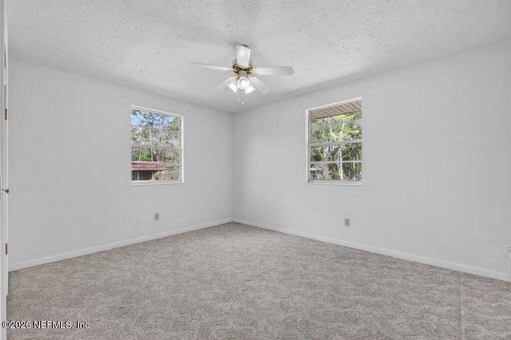 5785 George Hodges Road Macclenny, FL 32063 - Photo 34 of 55 an empty room with a window and a fan