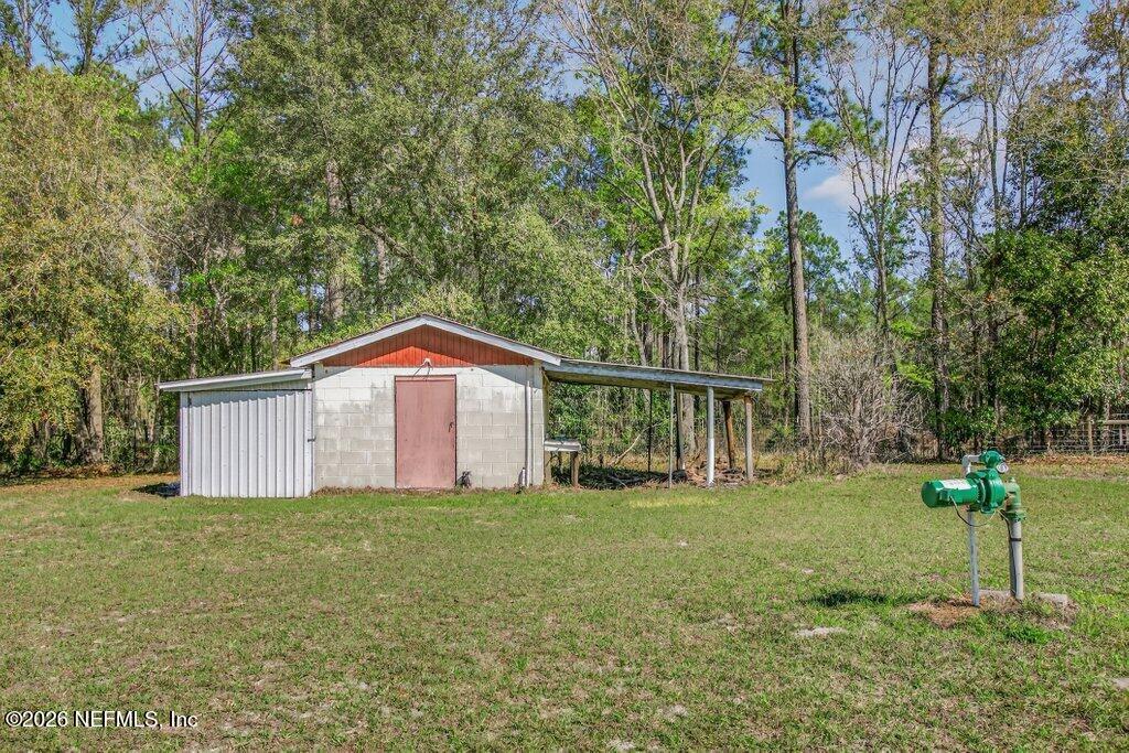 5785 George Hodges Road Macclenny, FL 32063 - Photo 49 of 55 a big house with a big yard and large trees