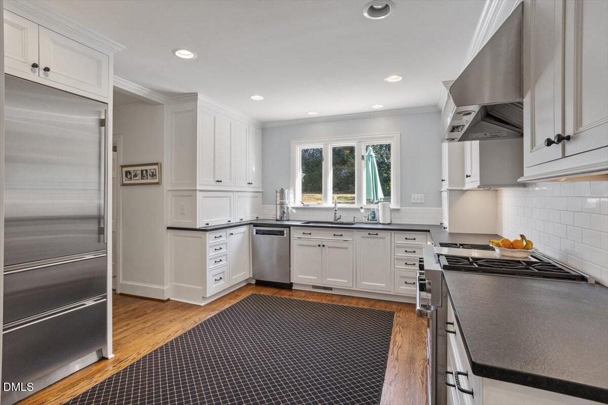 2416 East Lake Drive Raleigh, NC 27609 - Photo 11 of 42 a kitchen with a refrigerator sink and cabinets