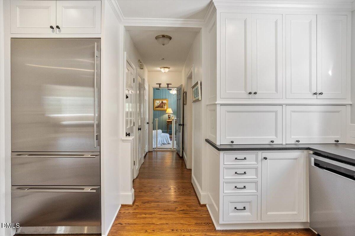 2416 East Lake Drive Raleigh, NC 27609 - Photo 13 of 42 a kitchen with white cabinets and refrigerator