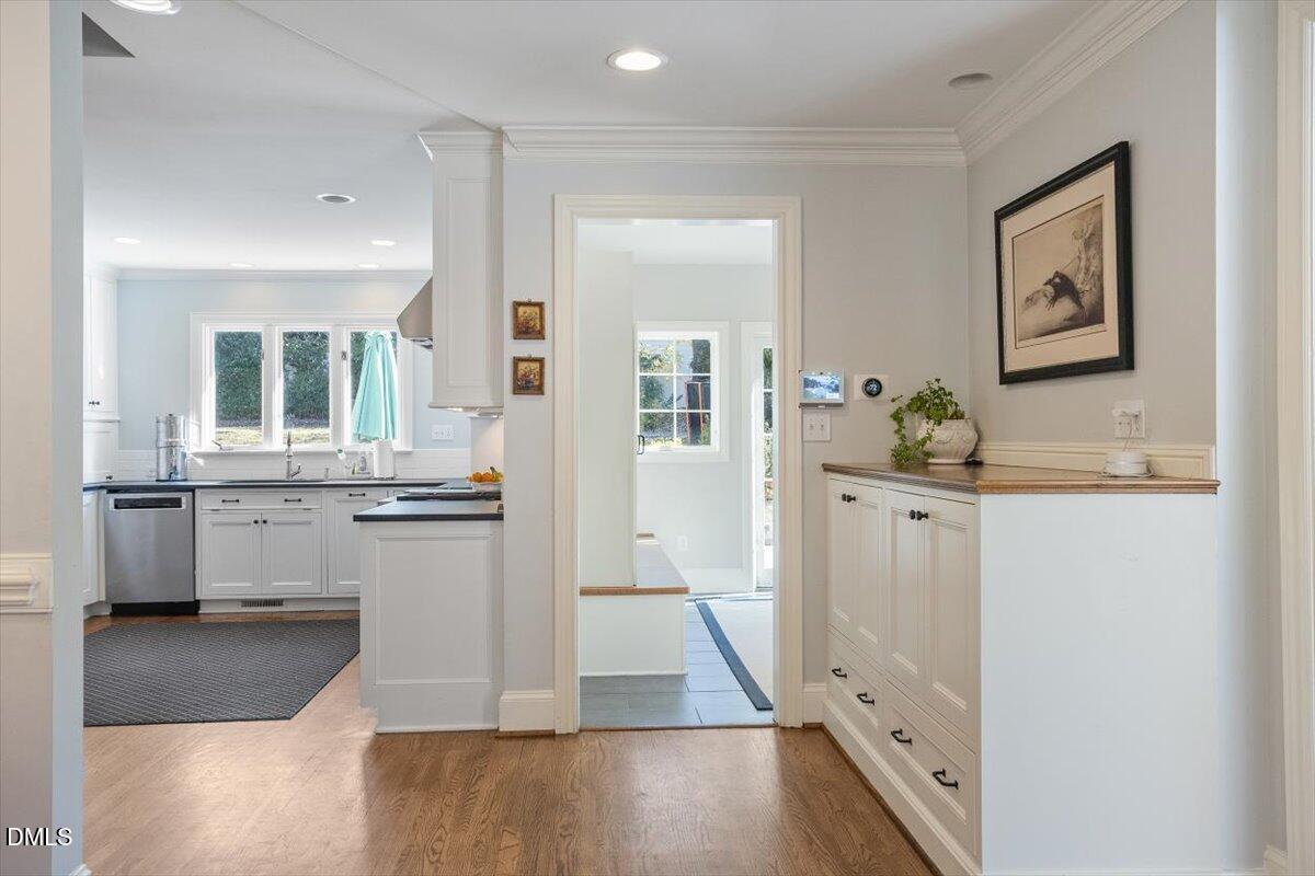 2416 East Lake Drive Raleigh, NC 27609 - Photo 14 of 42 a view of a hallway with wooden floor and a living room