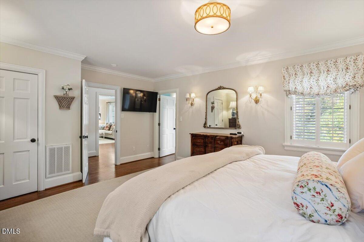 2416 East Lake Drive Raleigh, NC 27609 - Photo 23 of 42 a bedroom with a bed and a window