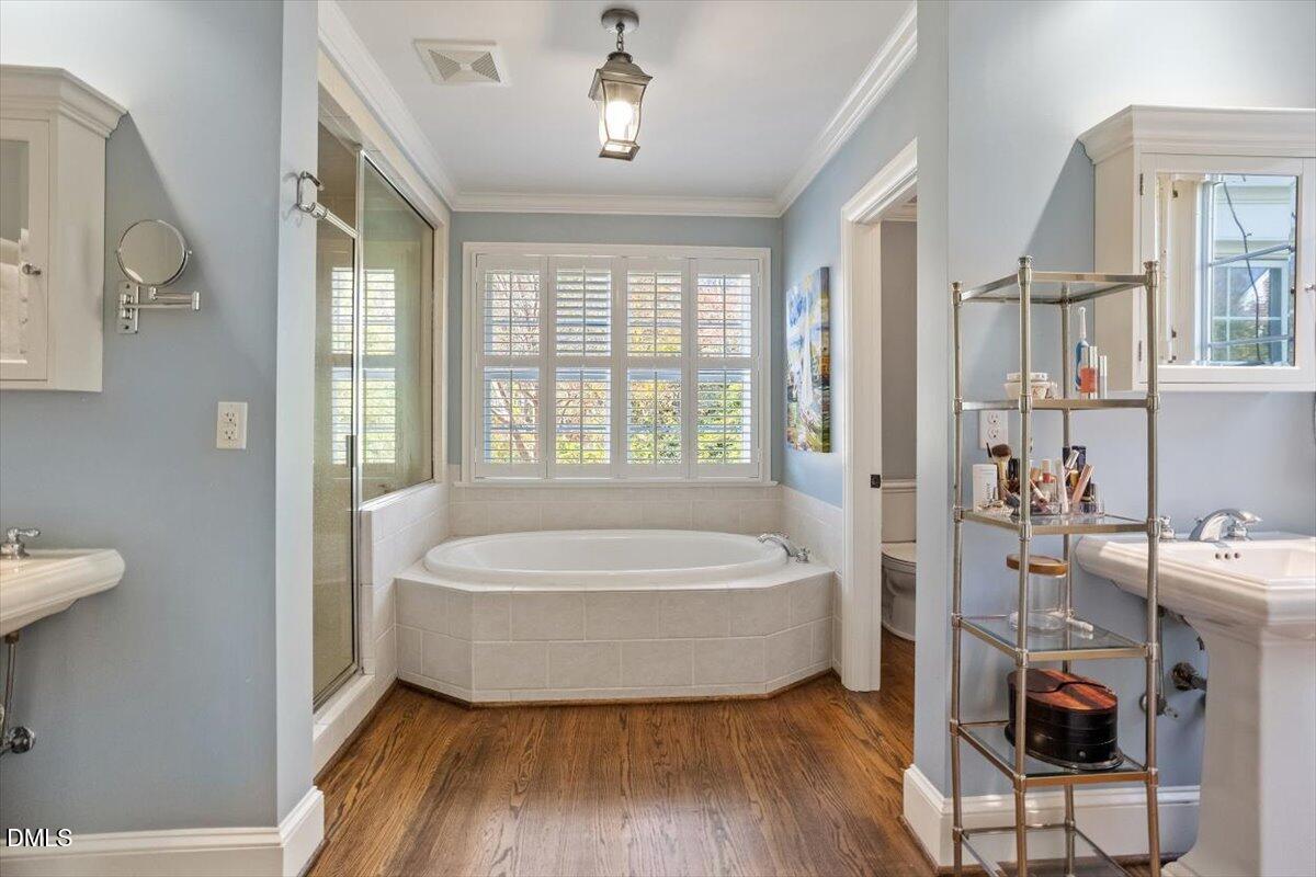 2416 East Lake Drive Raleigh, NC 27609 - Photo 24 of 42 a spacious bedroom with a bed and a window