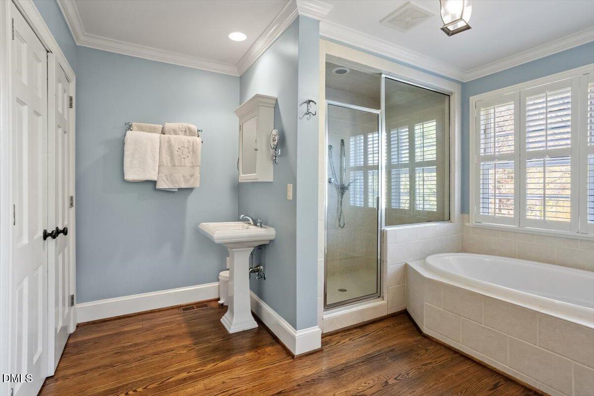 2416 East Lake Drive Raleigh, NC 27609 - Photo 26 of 42 a bathroom with a sink bathtub and a shower