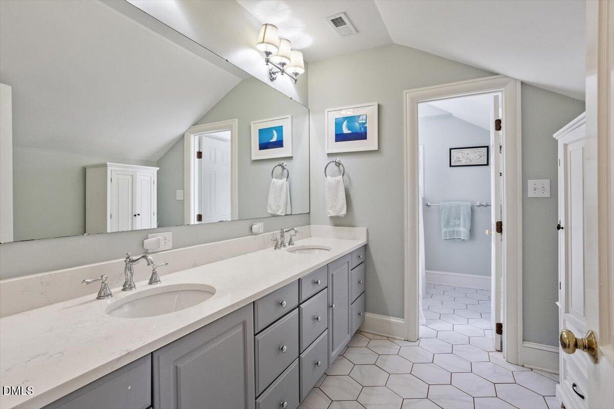 2416 East Lake Drive Raleigh, NC 27609 - Photo 30 of 42 a spacious bathroom with a double vanity sink mirror and double