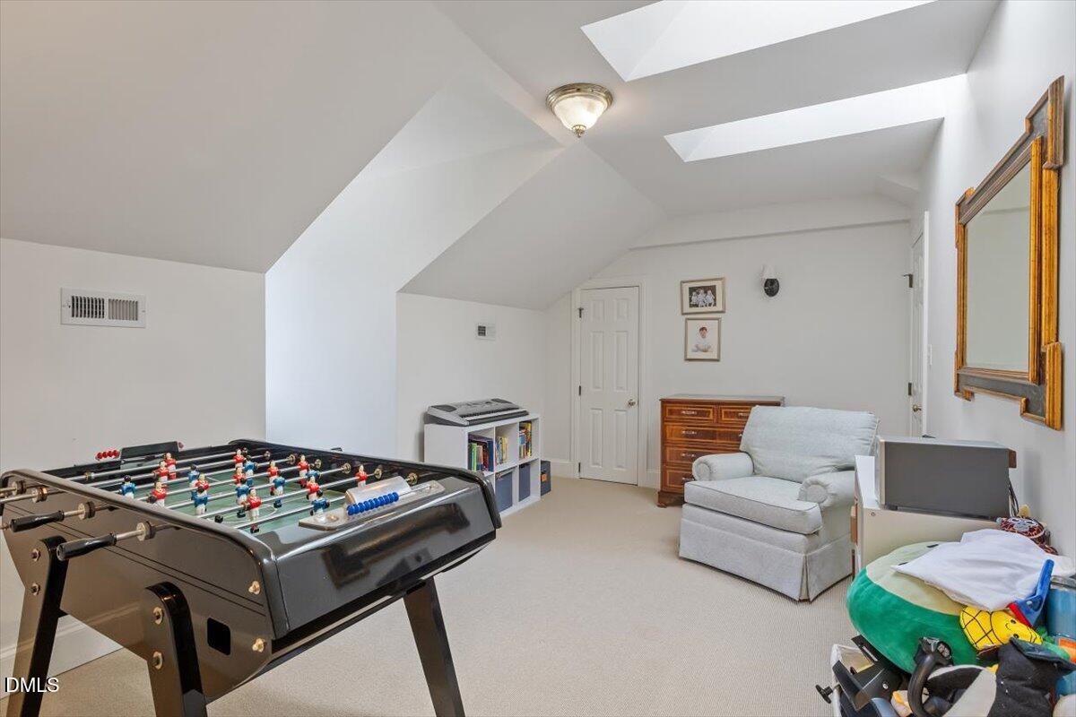 2416 East Lake Drive Raleigh, NC 27609 - Photo 31 of 42 a living room with furniture and a table