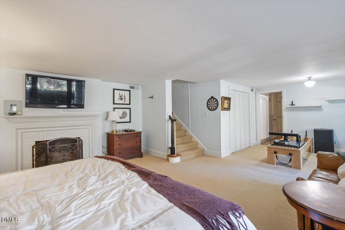 2416 East Lake Drive Raleigh, NC 27609 - Photo 34 of 42 a bedroom with a bed and a flat screen tv