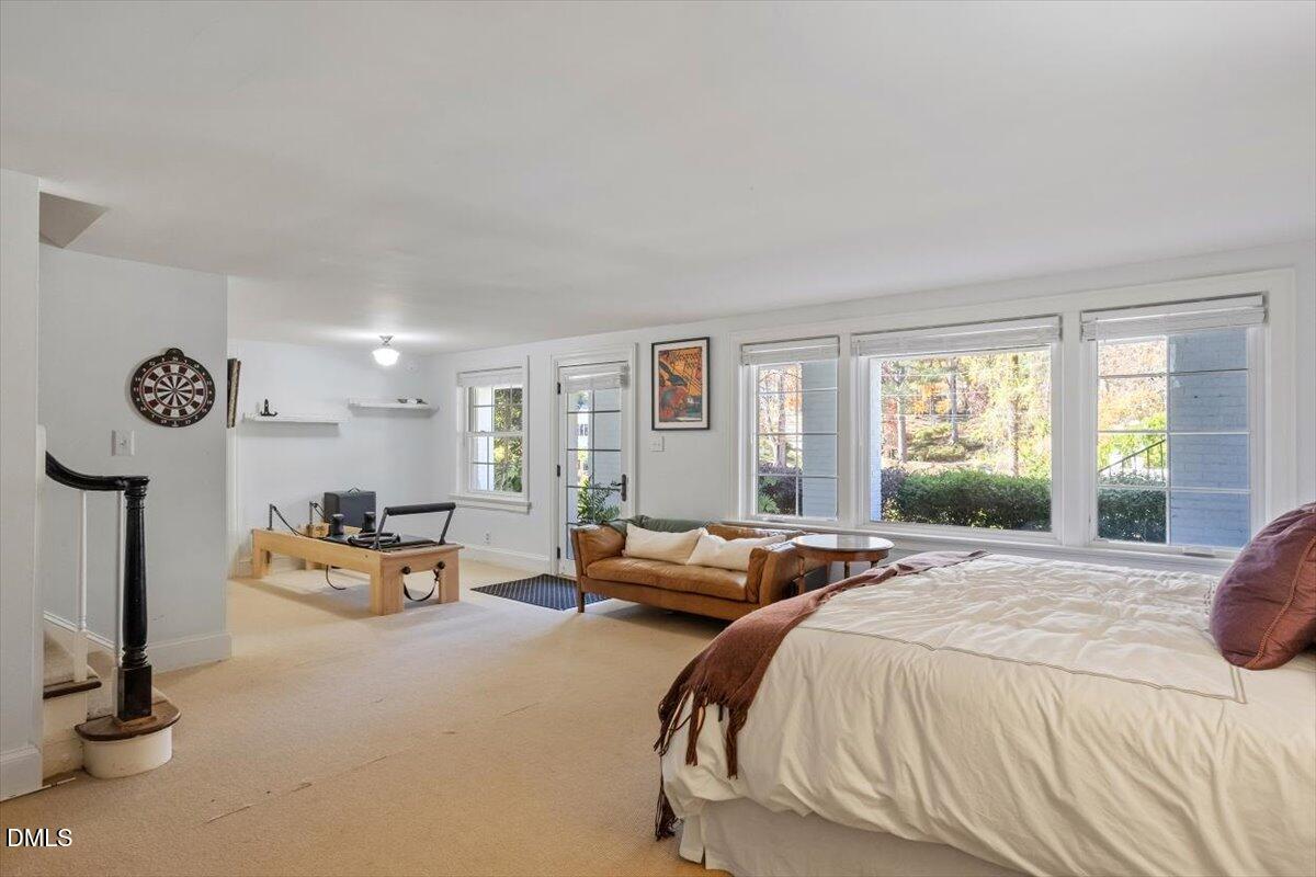 2416 East Lake Drive Raleigh, NC 27609 - Photo 35 of 42 a spacious bedroom with a bed and large windows