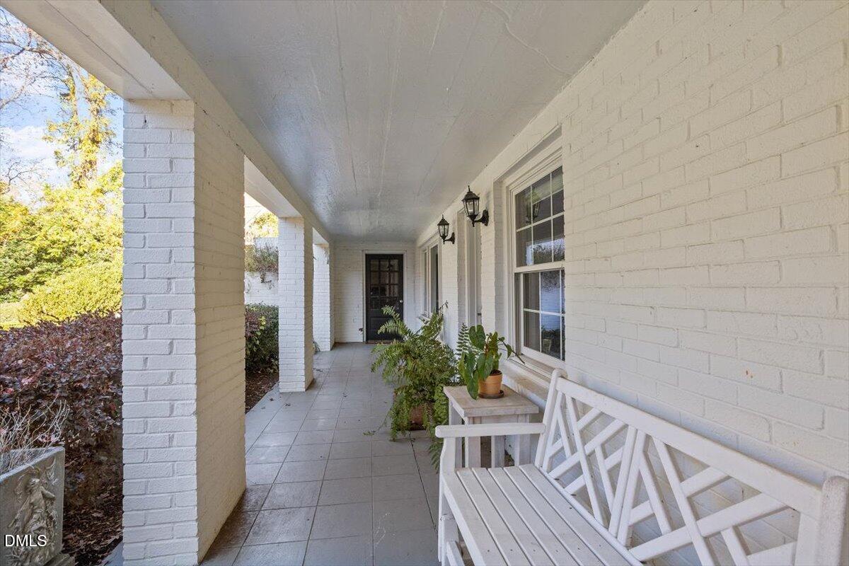 2416 East Lake Drive Raleigh, NC 27609 - Photo 36 of 42 a view of an entryway with wooden floor and a chair
