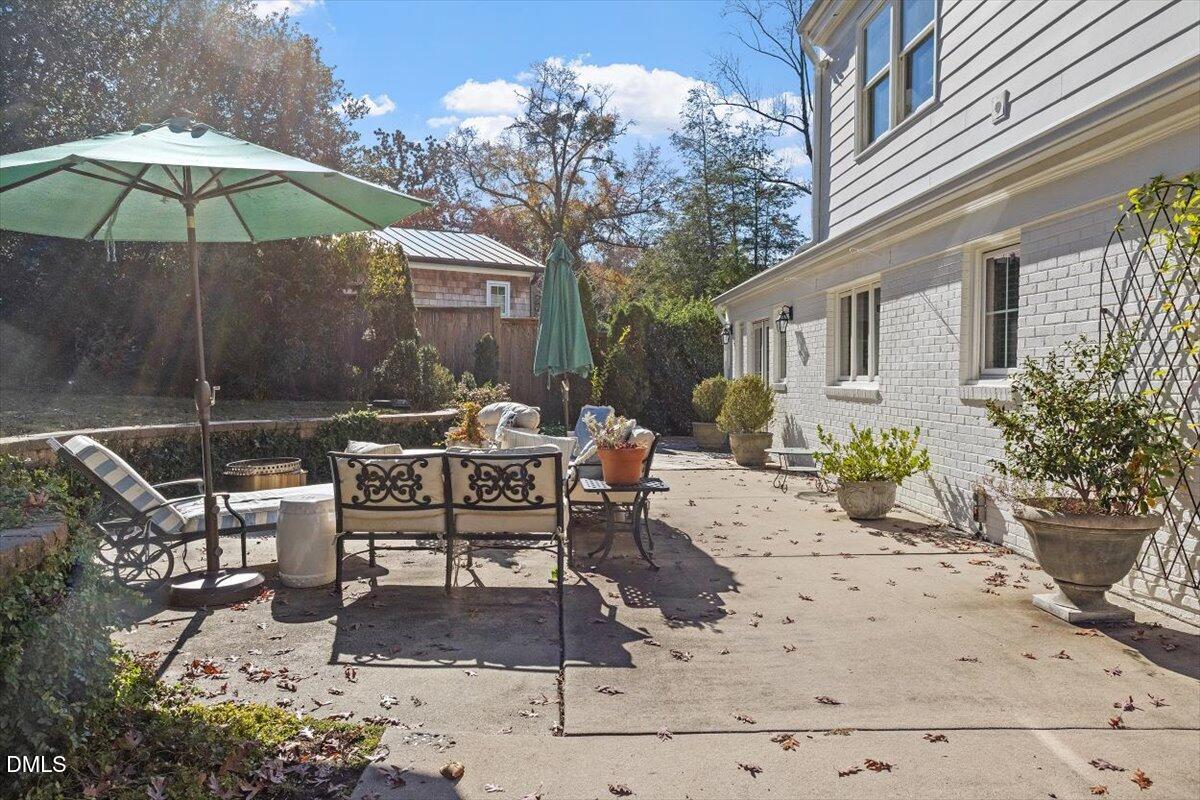 2416 East Lake Drive Raleigh, NC 27609 - Photo 38 of 42 a view of a patio with a table and chairs under an umbrella