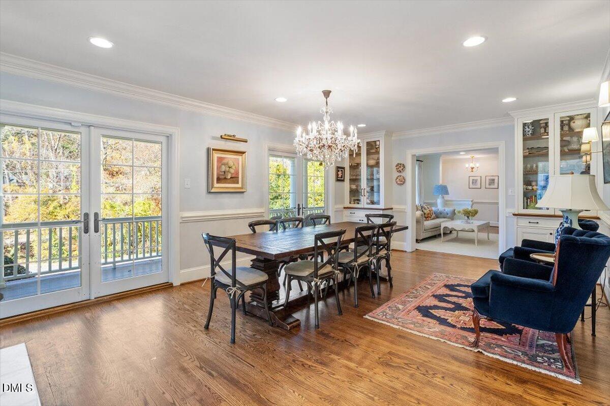 2416 East Lake Drive Raleigh, NC 27609 - Photo 9 of 42 a view of a dining room with furniture window and wooden floor