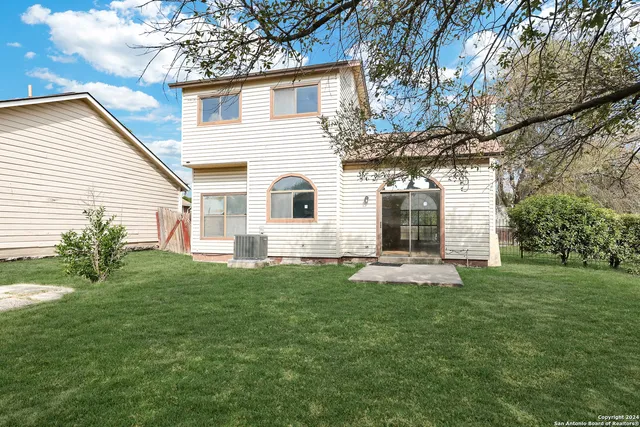 a house with huge green field in front of it