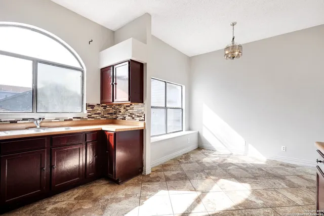 a large bathroom with a granite countertop sink and a large mirror