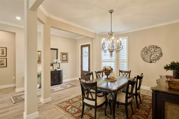 a living room with furniture kitchen view and a chandelier