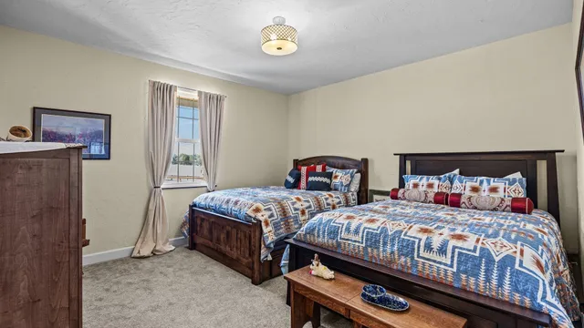 a bedroom with two beds and a closet