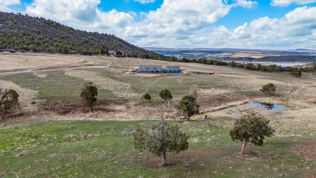 a view of a lake with beach and mountain in the back