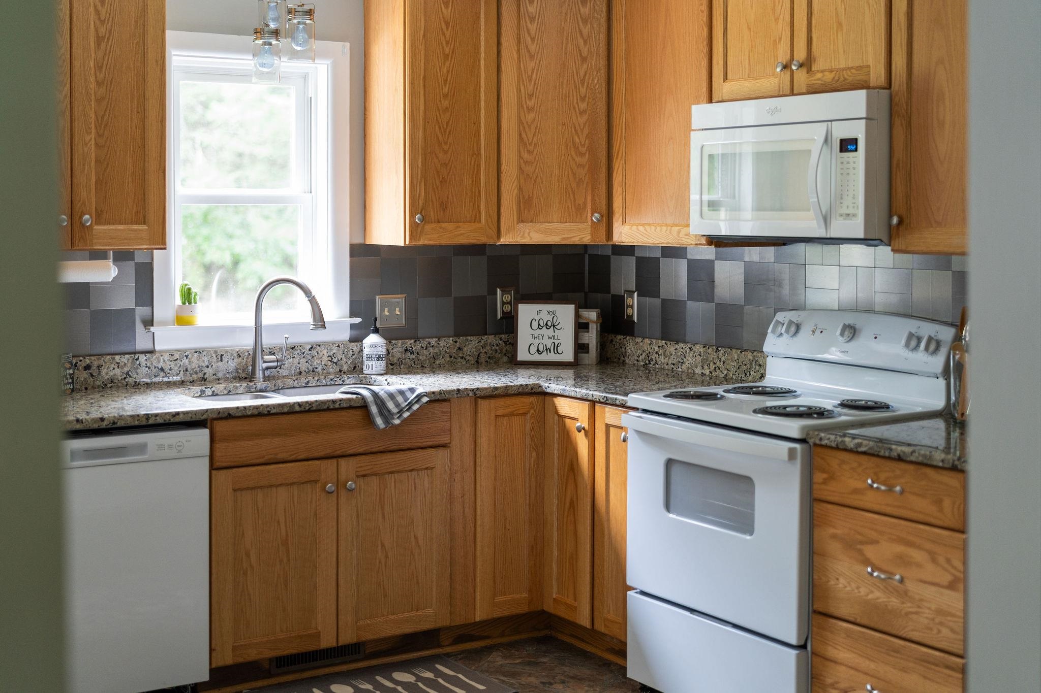 5264 Cold Springs Road Raphine, VA 24472 - Photo 11 of 57 a kitchen with stainless steel appliances granite countertop a sink stove and cabinets