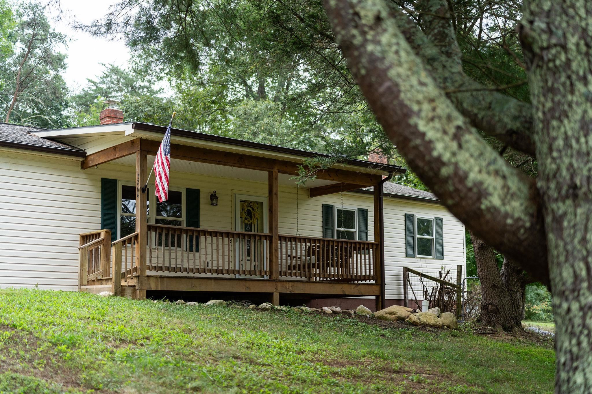 5264 Cold Springs Road Raphine, VA 24472 - Photo 2 of 57 a view of backyard with a deck and a large tree