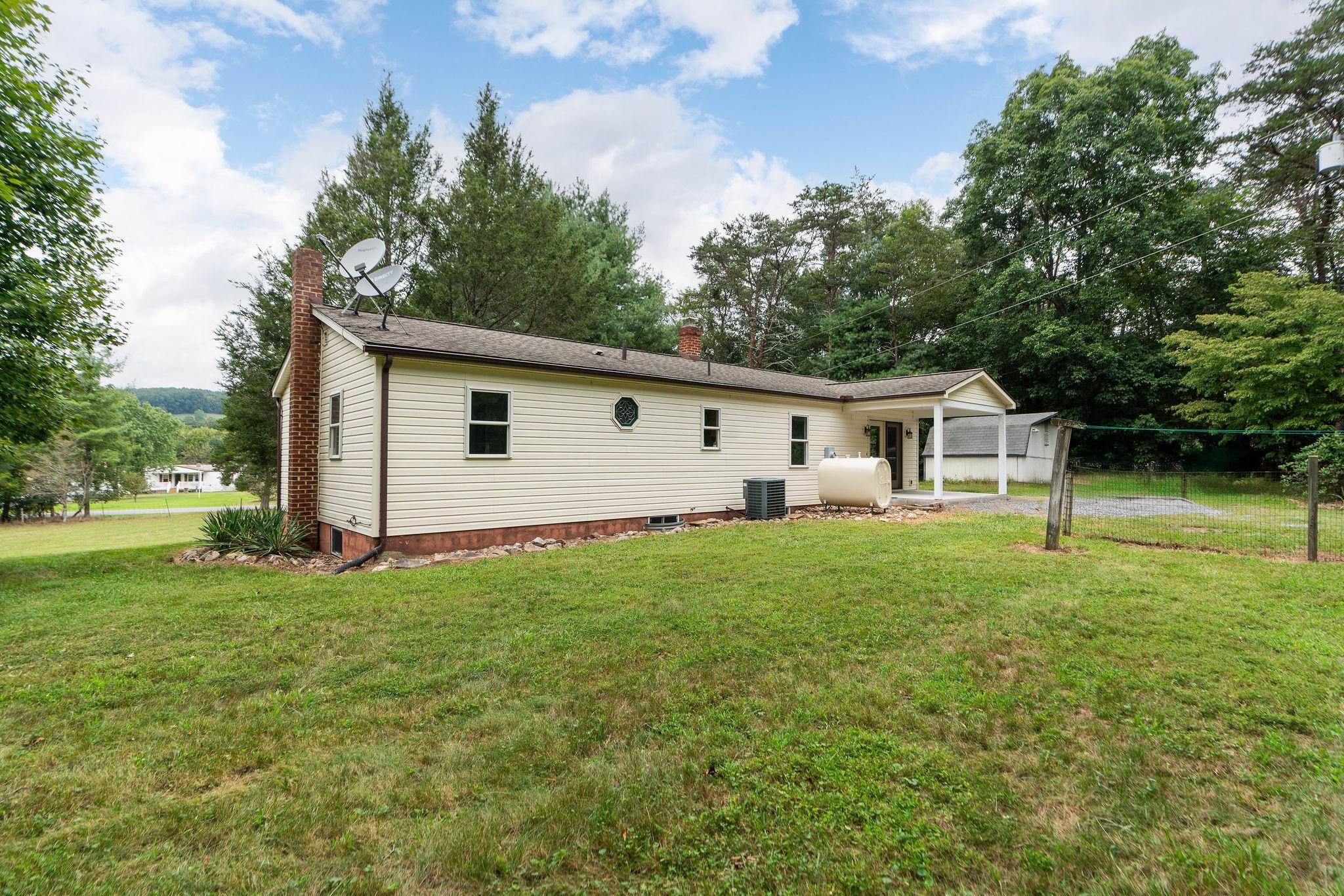 5264 Cold Springs Road Raphine, VA 24472 - Photo 51 of 57 a view of a backyard with plants and large trees