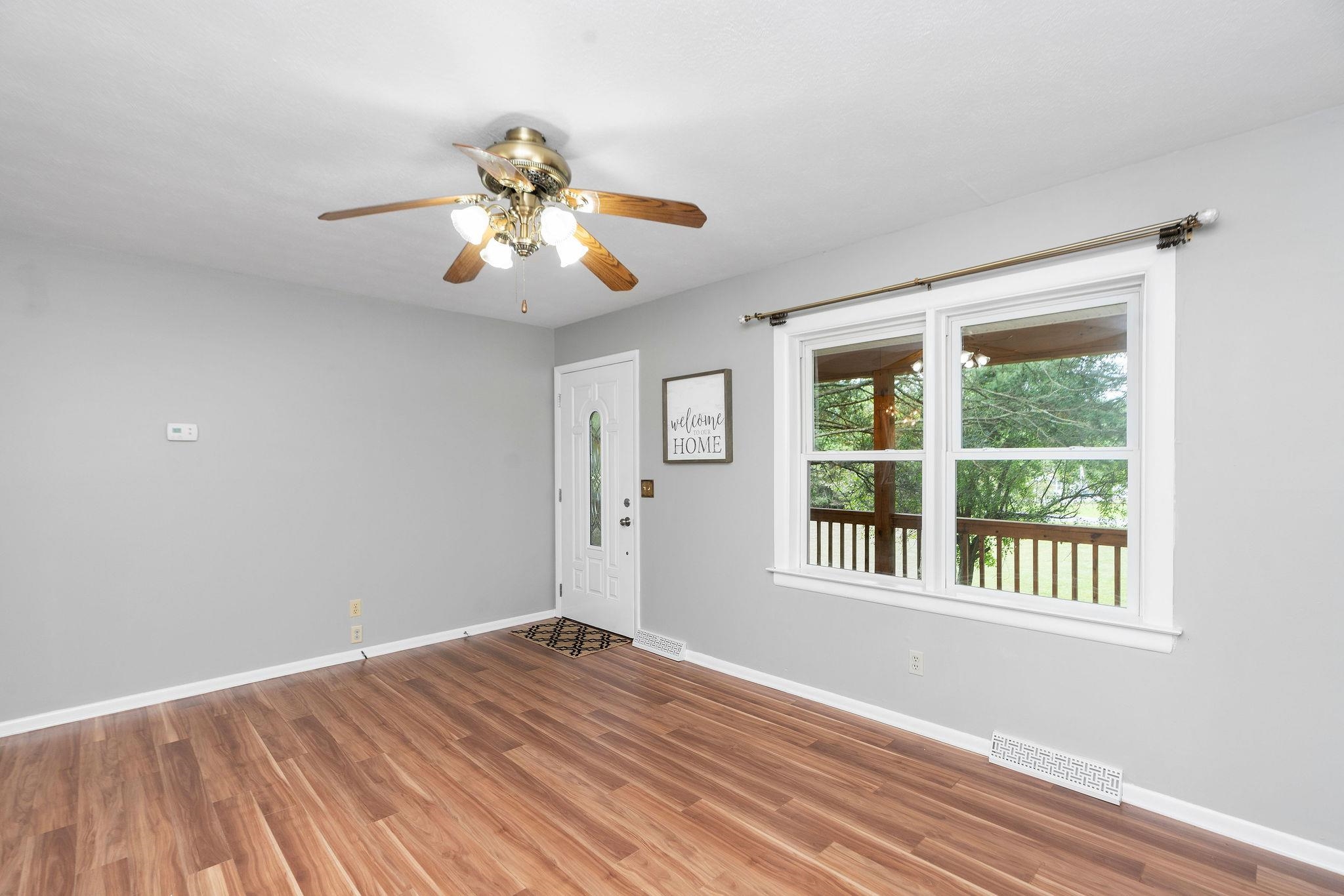5264 Cold Springs Road Raphine, VA 24472 - Photo 6 of 57 a view of empty room with wooden floor and fan