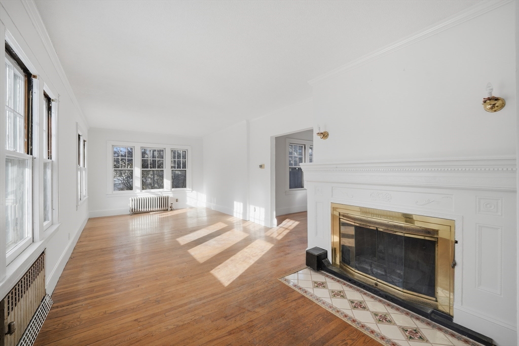 785 Dickinson Street Springfield, MA 01108 - Photo 13 of 36 an empty room with windows and fireplace