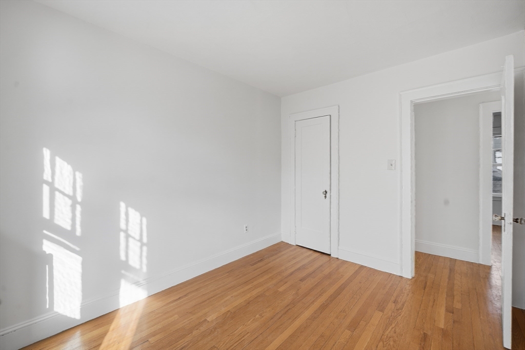 785 Dickinson Street Springfield, MA 01108 - Photo 24 of 36 a view of empty room with wooden floor and fan