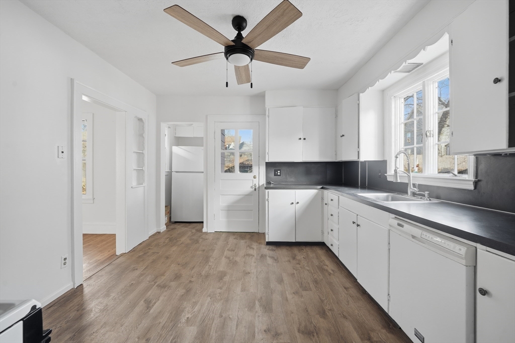 785 Dickinson Street Springfield, MA 01108 - Photo 8 of 36 a large kitchen with stainless steel appliances cabinets a sink and a window