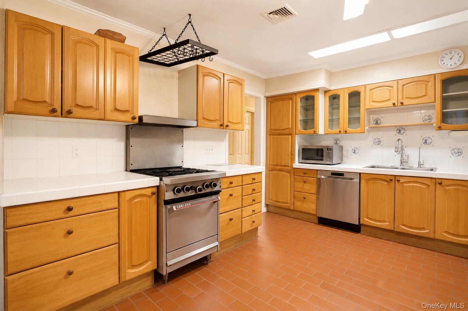 8 Swallow Avenue Spring Valley, NY 10977 - Photo 9 of 28 a kitchen with stainless steel appliances granite countertop a sink and cabinets