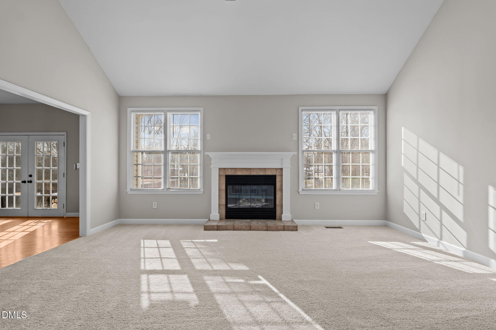2327 Olde Spring Court Graham, NC 27253 - Photo 13 of 49 a view of an empty room with a fireplace and a window