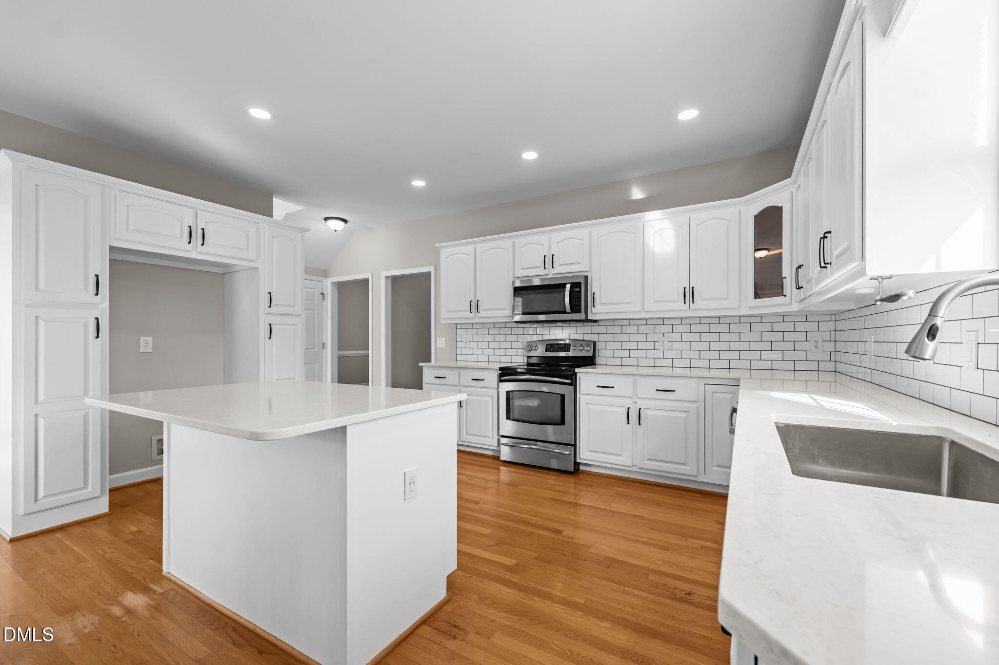 2327 Olde Spring Court Graham, NC 27253 - Photo 18 of 49 a kitchen with stainless steel appliances granite countertop a sink stove and refrigerator